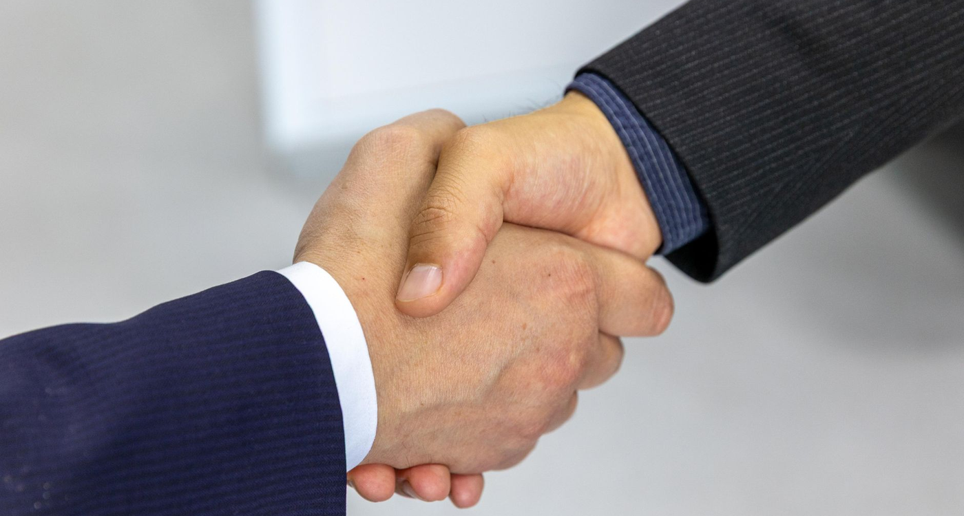 Essentrix Corporate Partnership Handshake